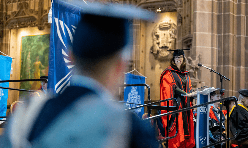 Clare Milsom at a lectern in the Anglican Cathedral 